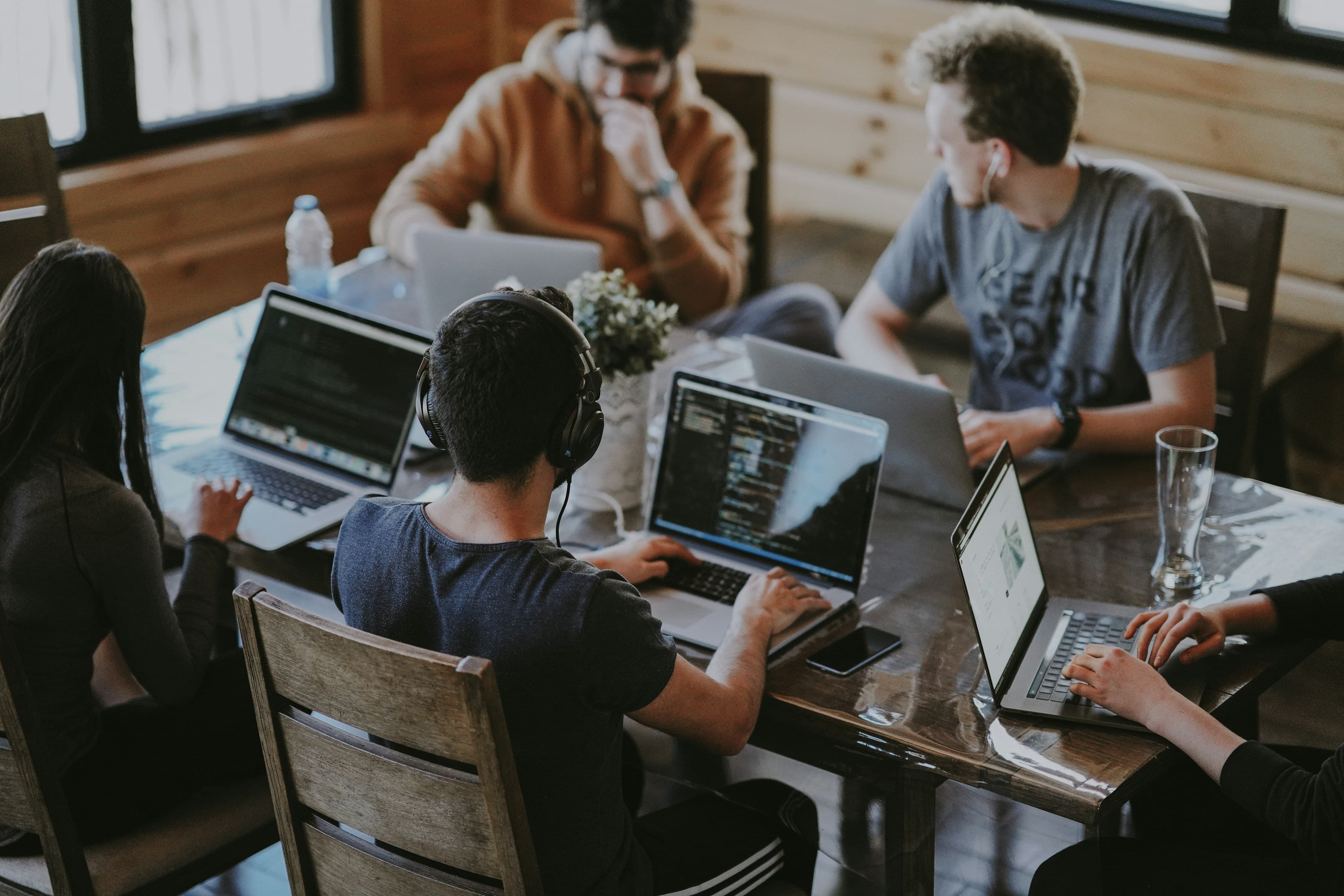 A small engineering team working together over laptops